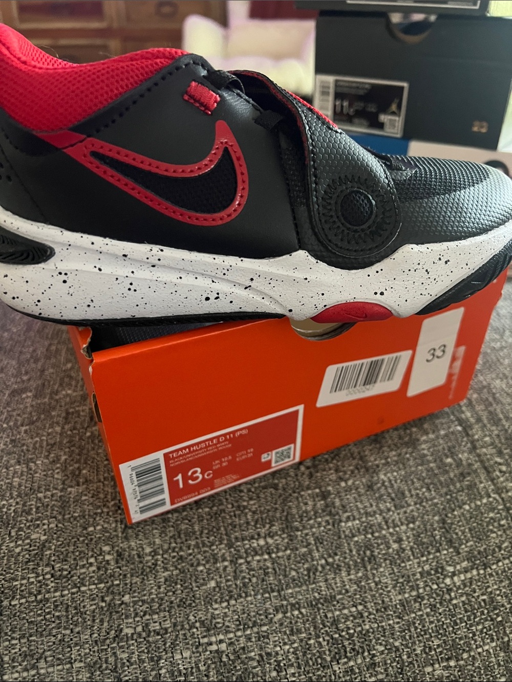 Nike Kids team hustle Black and Red Sneakers.